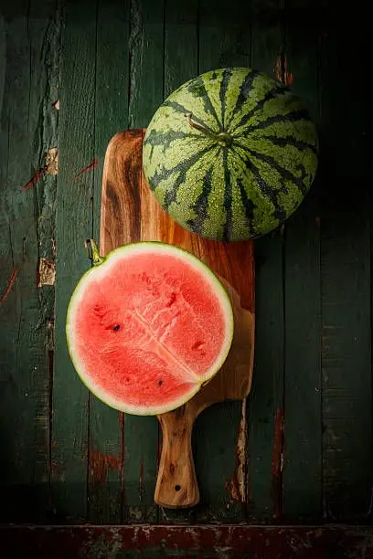 watermelon-sliced-on-wood-background.webp