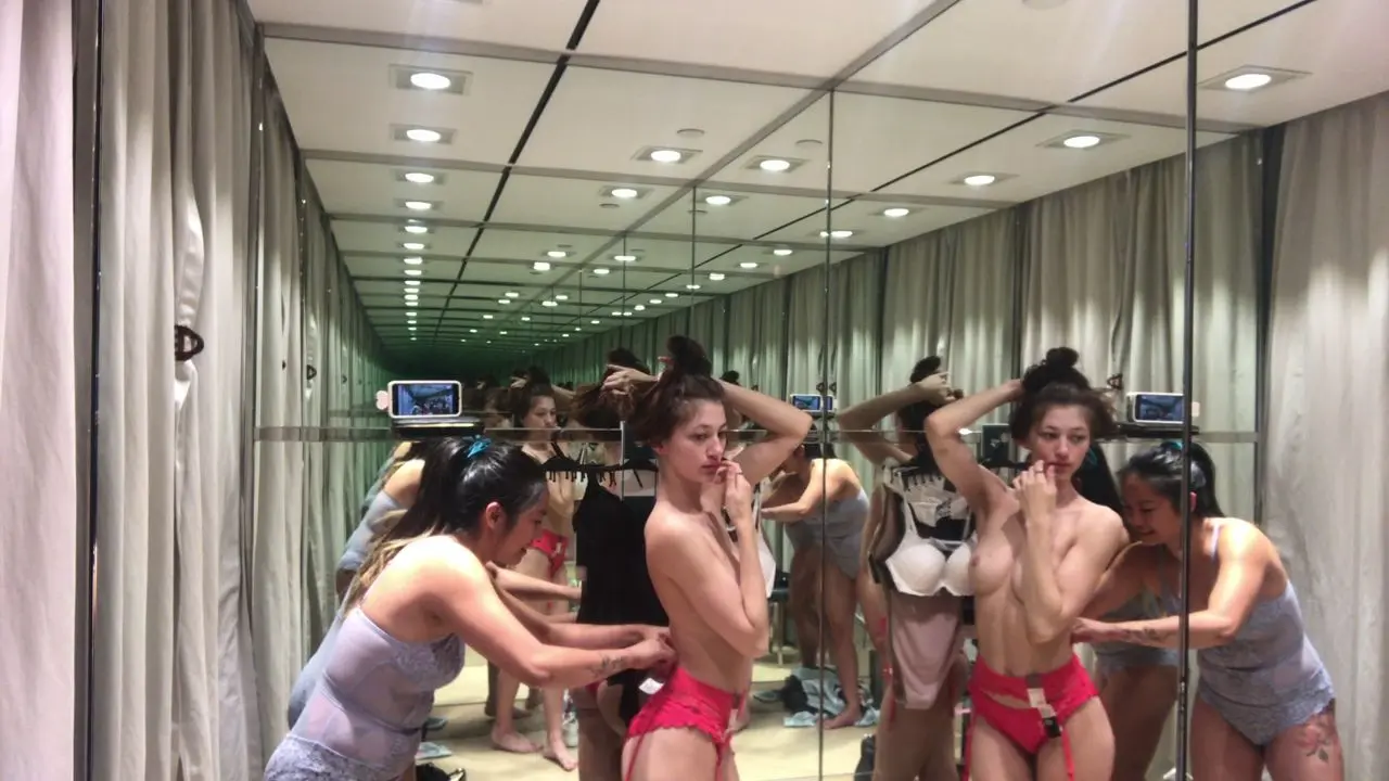 Two-mischievous-girls-in-the-fitting-room.webp